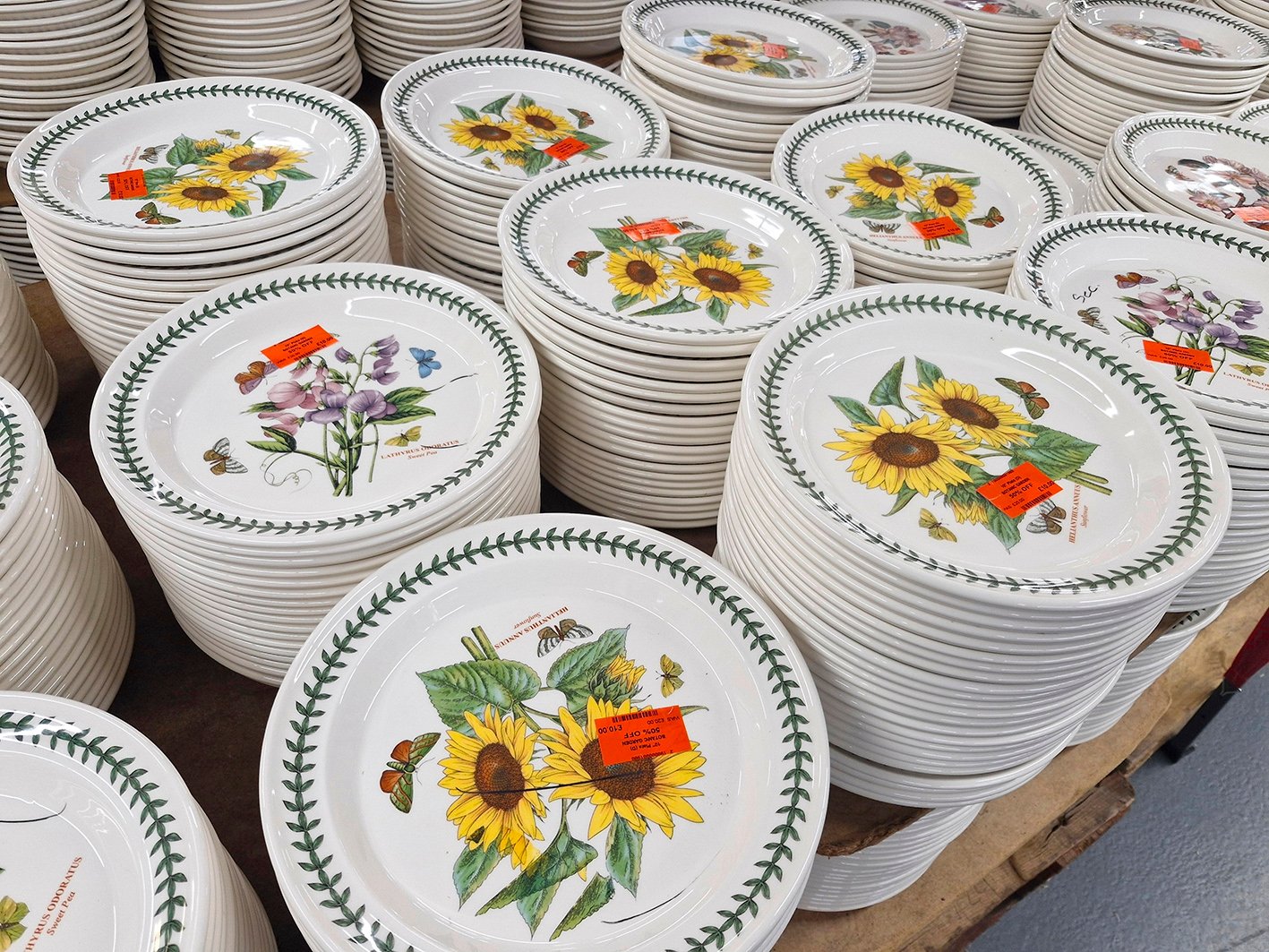 STOKE, STOKE-ON-TRENT, ENGLAND-JULY 13, 2025 : Dinner plates in flora and fauna pattern on sale during summer sale at Portmerion Group factory shop. The company is headquartered in Stoke-on-Trent, UK